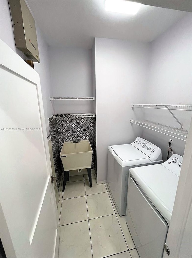 10824 Fillmore Dr, Boynton Beach, FL 33437 - laundry room featuring washer and dryer and light tile patterned flooring
