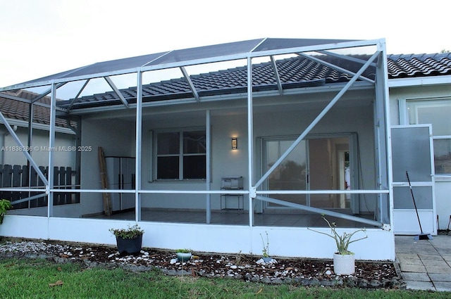 10824 Fillmore Dr, Boynton Beach, FL 33437 - back of house featuring glass enclosure, a tiled roof, and stucco siding