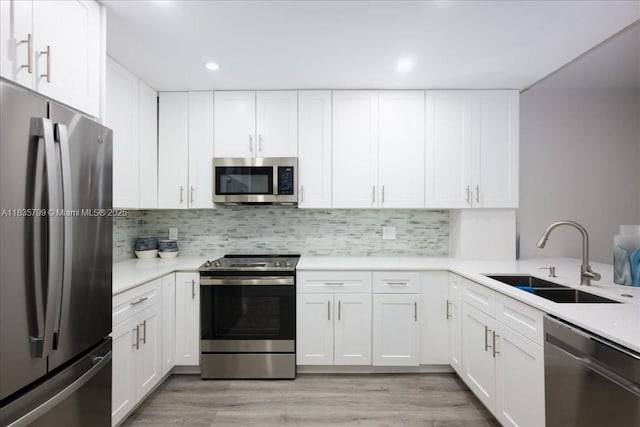 1200 SW 12th St Unit 214, Fort Lauderdale, FL 33315 - kitchen featuring appliances with stainless steel finishes, light countertops, white cabinetry, and recessed lighting
