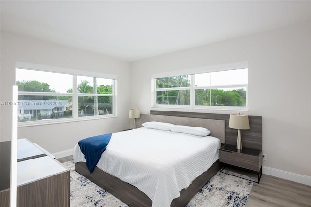 1200 SW 12th St Unit 214, Fort Lauderdale, FL 33315 - bedroom featuring baseboards and wood finished floors