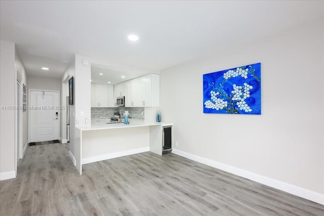 1200 SW 12th St Unit 214, Fort Lauderdale, FL 33315 - kitchen featuring stainless steel microwave, light wood finished floors, recessed lighting, stove, and light countertops