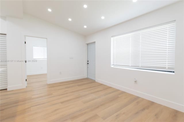 1896 NW 66th St, Miami, FL 33147 - spare room with light wood-style floors, vaulted ceiling, and recessed lighting