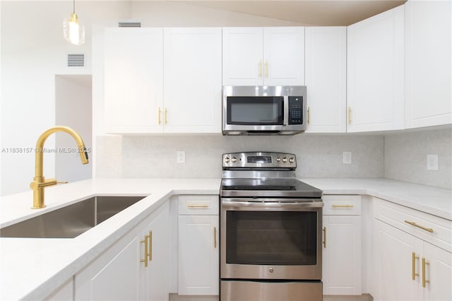 1896 NW 66th St, Miami, FL 33147 - kitchen featuring stainless steel appliances, white cabinetry, and backsplash