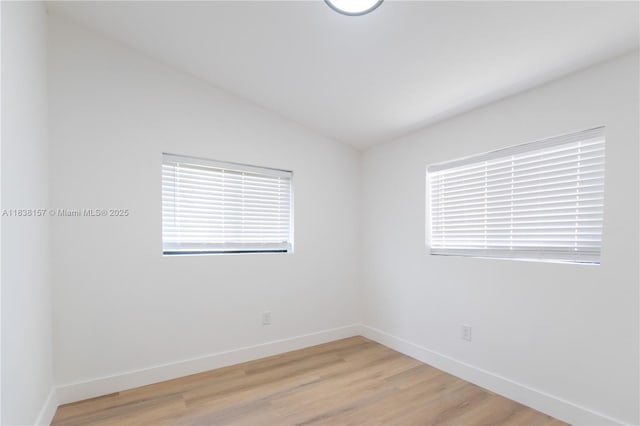 1896 NW 66th St, Miami, FL 33147 - empty room with vaulted ceiling, light wood-style floors, and plenty of natural light
