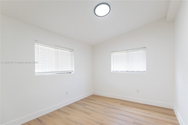 1896 NW 66th St, Miami, FL 33147 - spare room featuring lofted ceiling and light wood-style floors