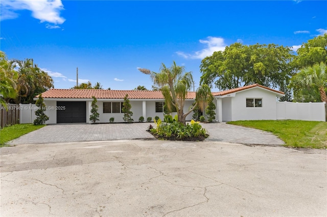 1710 SW 1st Ave, Pompano Beach, FL 33060 - view of front of property featuring decorative driveway, an attached garage, stucco siding, and a tiled roof