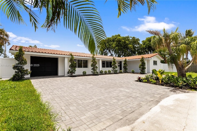 1710 SW 1st Ave, Pompano Beach, FL 33060 - view of front of house with decorative driveway, a garage, stucco siding, and a tiled roof