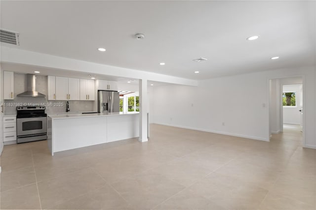 1710 SW 1st Ave, Pompano Beach, FL 33060 - kitchen with appliances with stainless steel finishes, wall chimney exhaust hood, light countertops, recessed lighting, and open floor plan
