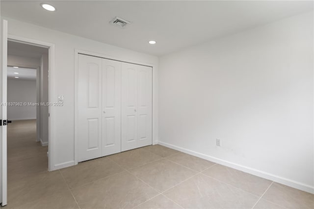 1710 SW 1st Ave, Pompano Beach, FL 33060 - unfurnished bedroom featuring recessed lighting, light tile patterned floors, and a closet