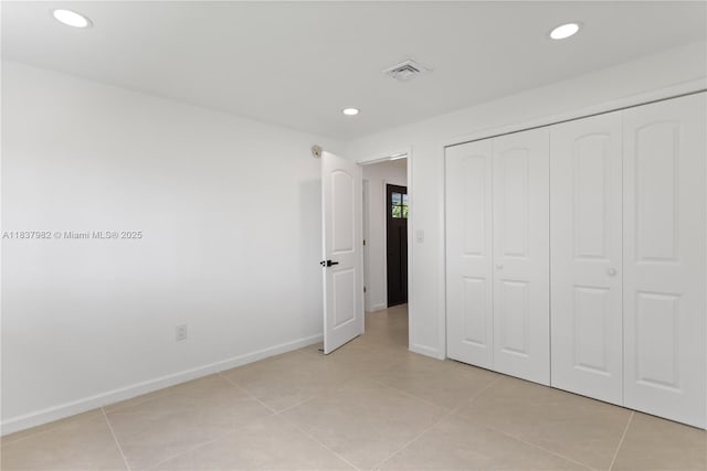 1710 SW 1st Ave, Pompano Beach, FL 33060 - unfurnished bedroom featuring recessed lighting, light tile patterned floors, and a closet