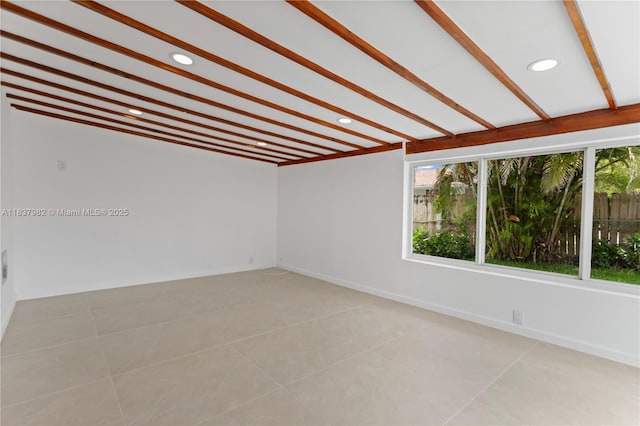 1710 SW 1st Ave, Pompano Beach, FL 33060 - unfurnished room with healthy amount of natural light, recessed lighting, light tile patterned flooring, and beam ceiling
