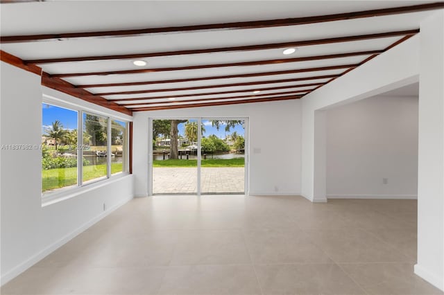1710 SW 1st Ave, Pompano Beach, FL 33060 - unfurnished room with a water view, beamed ceiling, recessed lighting, and light tile patterned floors