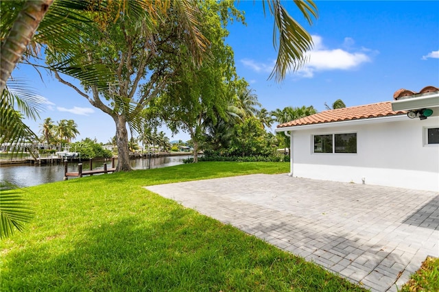 1710 SW 1st Ave, Pompano Beach, FL 33060 - view of green lawn featuring a water view and a patio