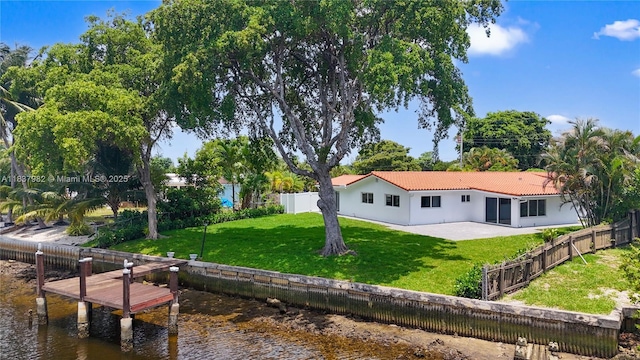 1710 SW 1st Ave, Pompano Beach, FL 33060 - rear view of property featuring a tile roof, a water view, a patio area, and stucco siding