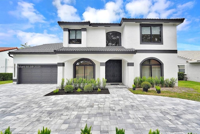 10746 Charleston Pl, Cooper City, FL 33026 - mediterranean / spanish house with decorative driveway, stucco siding, an attached garage, and a tiled roof