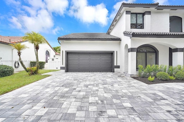 10746 Charleston Pl, Cooper City, FL 33026 - mediterranean / spanish home featuring decorative driveway, an attached garage, stucco siding, and a tile roof