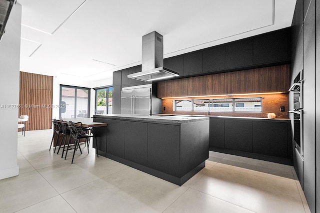 10746 Charleston Pl, Cooper City, FL 33026 - kitchen with dark cabinetry, modern cabinets, wall chimney range hood, stainless steel appliances, and tasteful backsplash