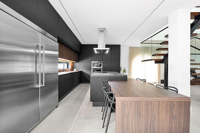 10746 Charleston Pl, Cooper City, FL 33026 - kitchen featuring appliances with stainless steel finishes, dark cabinetry, modern cabinets, island exhaust hood, and finished concrete flooring