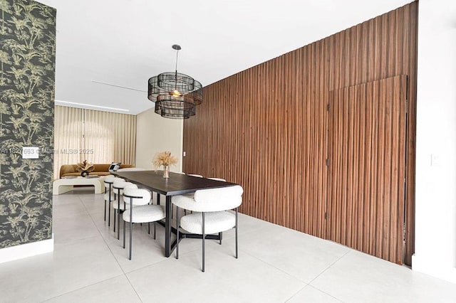 10746 Charleston Pl, Cooper City, FL 33026 - dining space with wallpapered walls, a chandelier, light tile patterned flooring, and wood walls