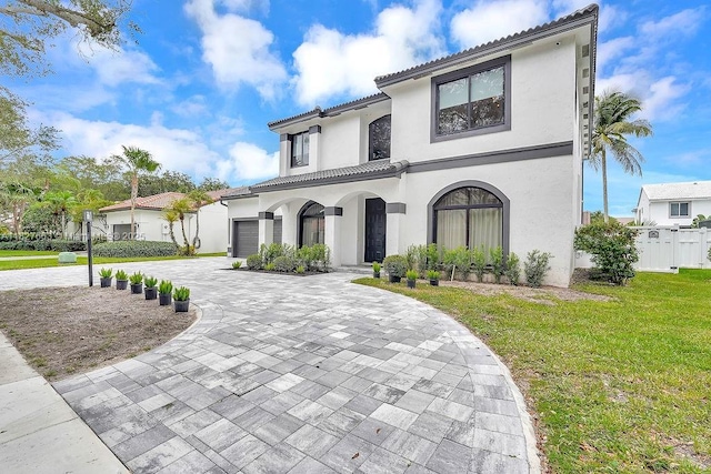 10746 Charleston Pl, Cooper City, FL 33026 - mediterranean / spanish-style house with decorative driveway, stucco siding, a tile roof, and an attached garage