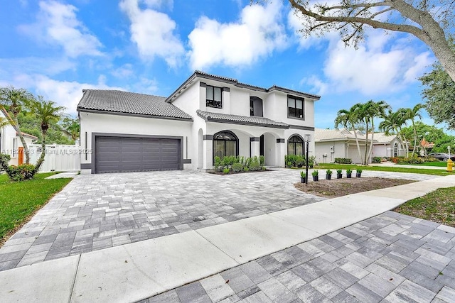 10746 Charleston Pl, Cooper City, FL 33026 - mediterranean / spanish house featuring stucco siding, decorative driveway, an attached garage, and a tile roof