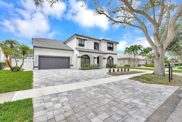 10746 Charleston Pl, Cooper City, FL 33026 - mediterranean / spanish house featuring decorative driveway, a garage, a tiled roof, and stucco siding