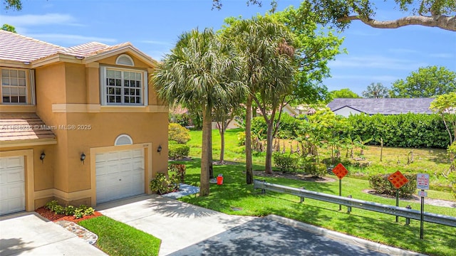10104 Royal Palm Blvd Unit 107-C, Coral Springs, FL 33065 - view of front of property with stucco siding, a front lawn, a garage, and driveway