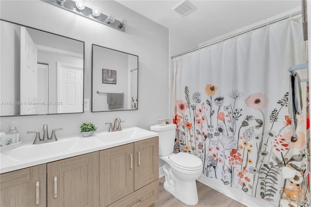 10104 Royal Palm Blvd Unit 107-C, Coral Springs, FL 33065 - bathroom with double vanity, wood finished floors, and curtained shower
