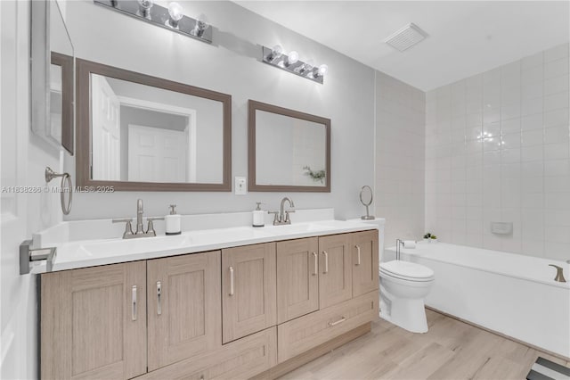 10104 Royal Palm Blvd Unit 107-C, Coral Springs, FL 33065 - full bath with double vanity, a tub to relax in, and wood finished floors