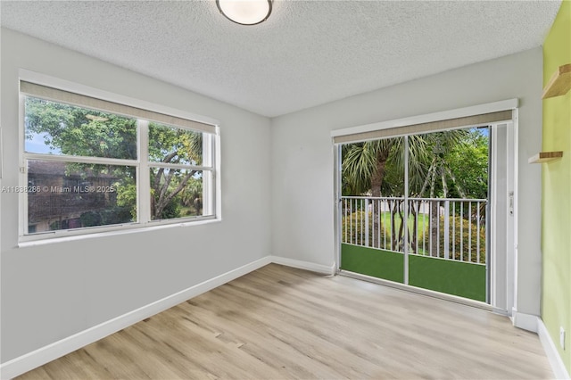 10104 Royal Palm Blvd Unit 107-C, Coral Springs, FL 33065 - empty room with wood finished floors and a textured ceiling