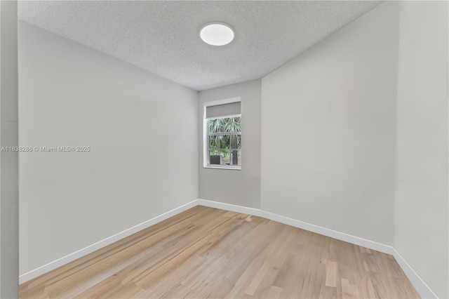 10104 Royal Palm Blvd Unit 107-C, Coral Springs, FL 33065 - spare room featuring light wood-type flooring and a textured ceiling