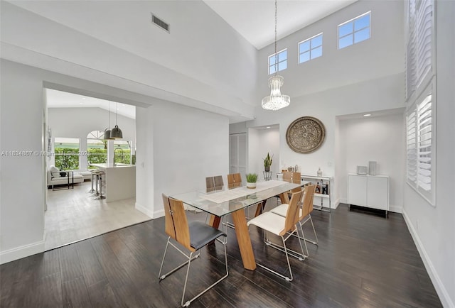15281 Wilshire Ct, Pembroke Pines, FL 33027 - dining room featuring wood finished floors, healthy amount of natural light, a chandelier, and a towering ceiling