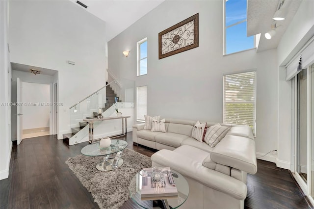 15281 Wilshire Ct, Pembroke Pines, FL 33027 - living room with a towering ceiling, stairs, healthy amount of natural light, and dark wood-style flooring