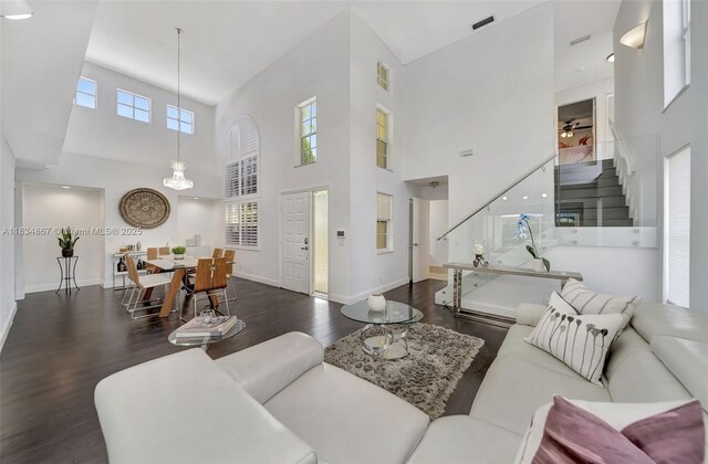 15281 Wilshire Ct, Pembroke Pines, FL 33027 - living area with stairway, dark wood-style floors, and a high ceiling