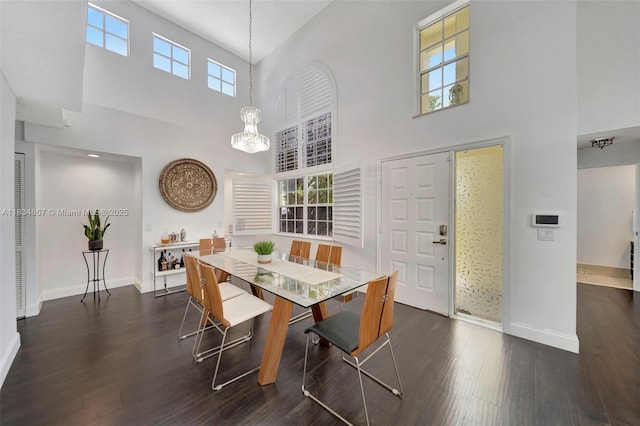 15281 Wilshire Ct, Pembroke Pines, FL 33027 - dining space with a towering ceiling, dark wood finished floors, and a chandelier