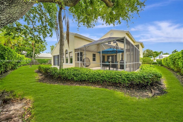 15281 Wilshire Ct, Pembroke Pines, FL 33027 - rear view of property featuring a lawn, a lanai, a patio, and stucco siding