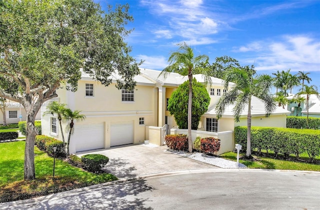 15281 Wilshire Ct, Pembroke Pines, FL 33027 - view of front of home with stucco siding, an attached garage, and concrete driveway