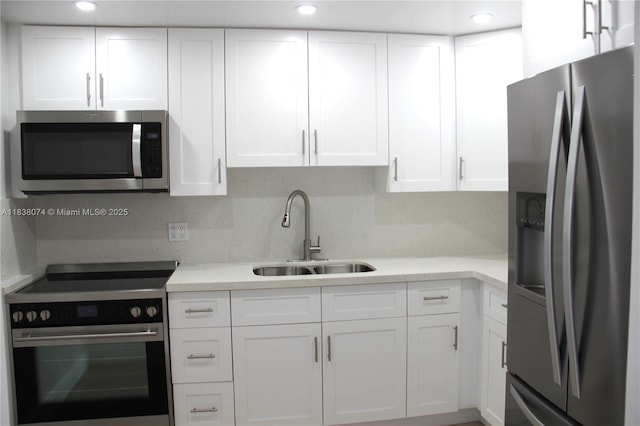 1075 W 68th St Unit 110, Hialeah, FL 33014 - kitchen with appliances with stainless steel finishes, white cabinetry, light countertops, and recessed lighting