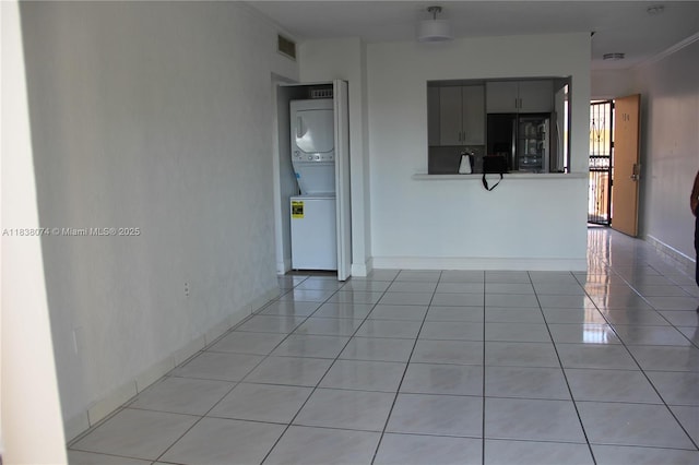 1075 W 68th St Unit 110, Hialeah, FL 33014 - empty room featuring stacked washer and clothes dryer and light tile patterned floors