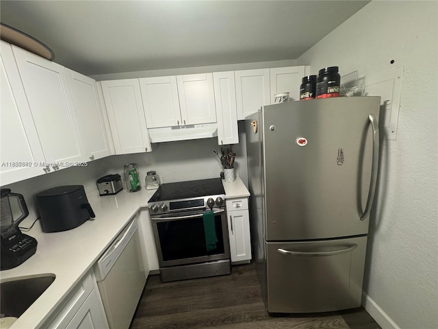 4235 N University Dr Unit 312, Sunrise, FL 33351 - kitchen with stainless steel appliances, under cabinet range hood, dark wood finished floors, white cabinets, and light countertops