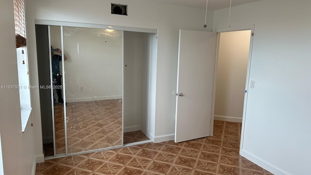 8680 NW 3rd Ln Unit 303, Miami, FL 33126 - unfurnished bedroom featuring a closet and tile patterned floors
