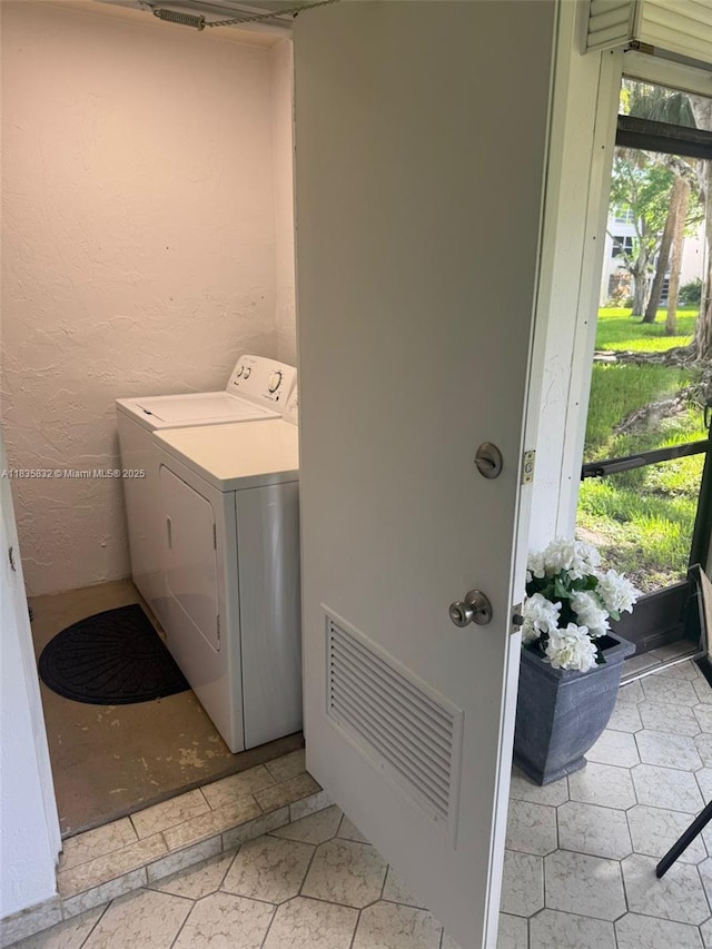 7480 NW 17th St Unit 103, Plantation, FL 33313 - laundry room featuring washer / clothes dryer and plenty of natural light