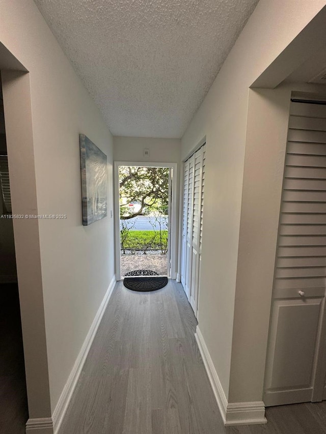 7480 NW 17th St Unit 103, Plantation, FL 33313 - hallway with a textured ceiling and wood finished floors
