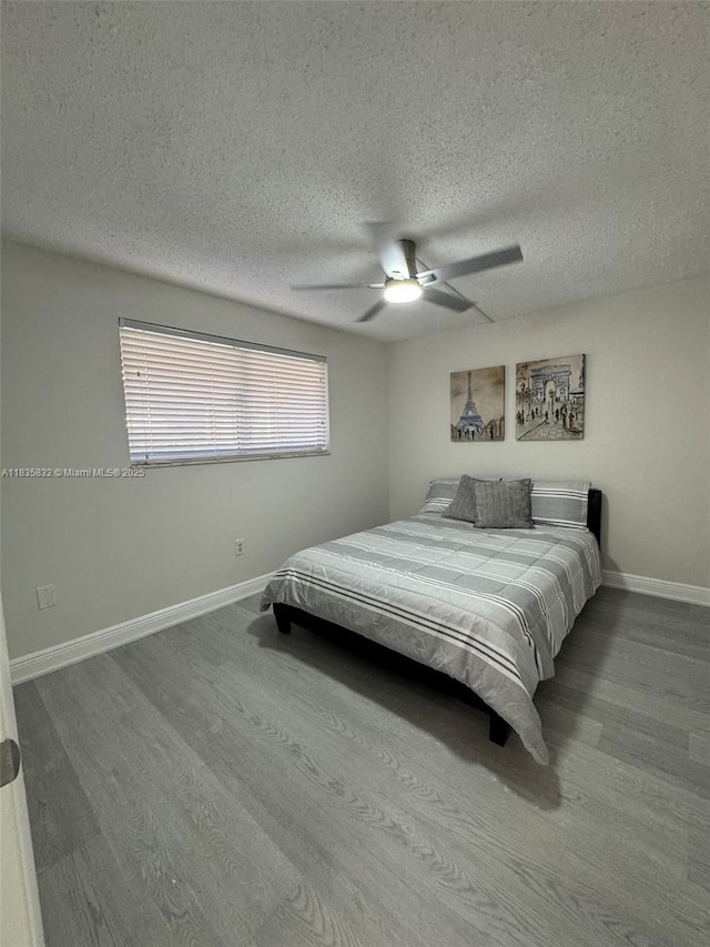 7480 NW 17th St Unit 103, Plantation, FL 33313 - bedroom with wood finished floors, a textured ceiling, and ceiling fan