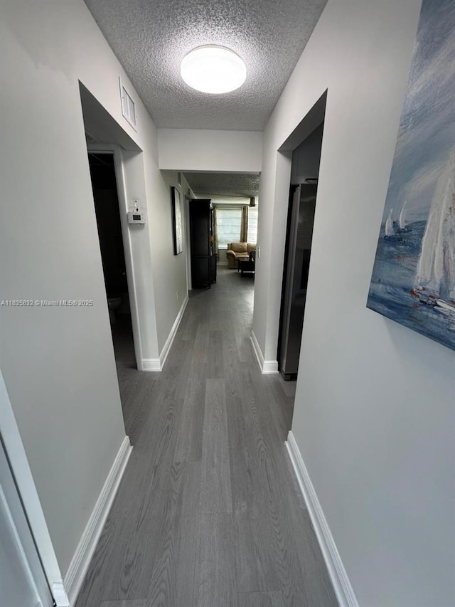 7480 NW 17th St Unit 103, Plantation, FL 33313 - hallway with a textured ceiling and dark wood-style floors