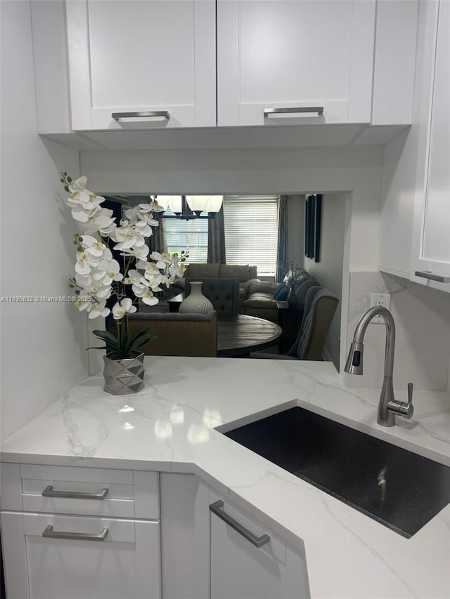 7480 NW 17th St Unit 103, Plantation, FL 33313 - kitchen view of white cabinetry and light stone counters