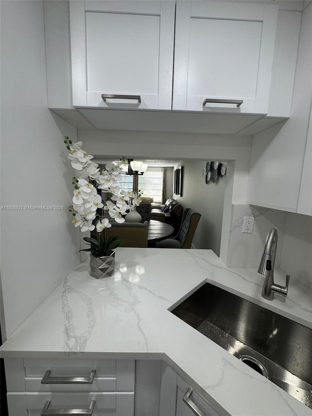 7480 NW 17th St Unit 103, Plantation, FL 33313 - kitchen view of white cabinetry and light stone counters