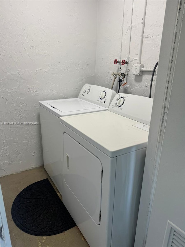 7480 NW 17th St Unit 103, Plantation, FL 33313 - laundry area with a textured wall and independent washer and dryer