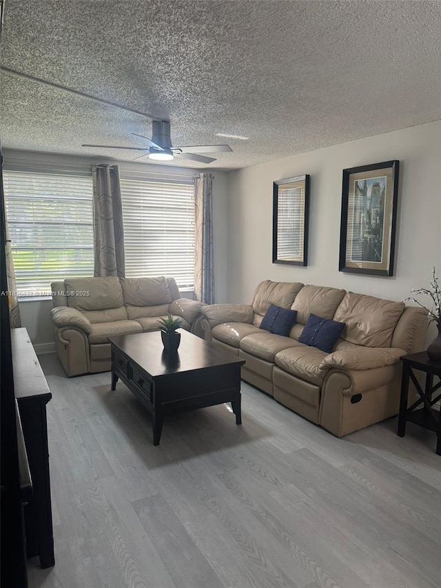 7480 NW 17th St Unit 103, Plantation, FL 33313 - living room featuring light wood-style flooring, a ceiling fan, healthy amount of natural light, and a textured ceiling