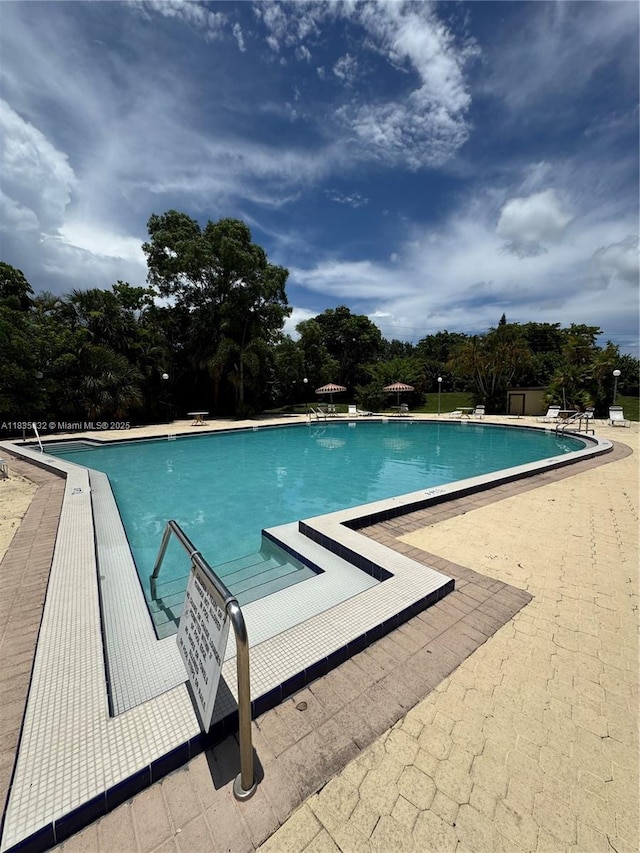 7480 NW 17th St Unit 103, Plantation, FL 33313 - community pool featuring a patio and view of scattered trees